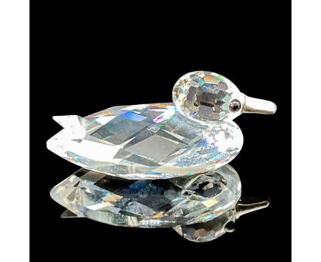 This duck figurine showcases a faceted clear crystal body, perfectly capturing its graceful form, and is complemented by a si