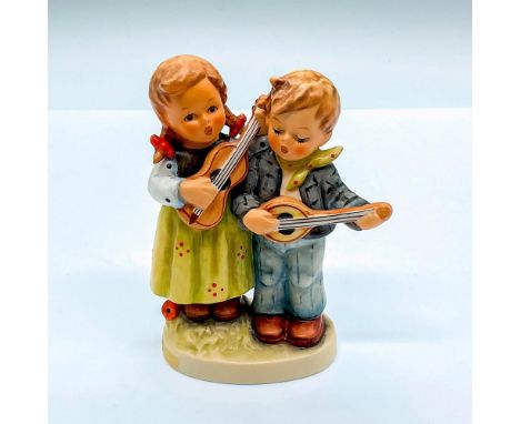 Hand painted figure of a young boy and girl playing music. Goebel Hummel backstamp. HUM 150 2/0. Issued: c. 1990-1999Dimensio