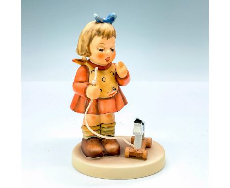 This figurine features a girl pulling a toy pony, signed by Master Painter on 5/3/02. Goebel backstamp TMK8. Issued: 2002Dime