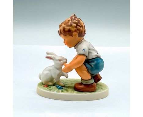 Exclusive edition hand painted figure of a young boy talking to a white rabbit. Goebel Hummel backstamp. HUM 615. Issued: c. 