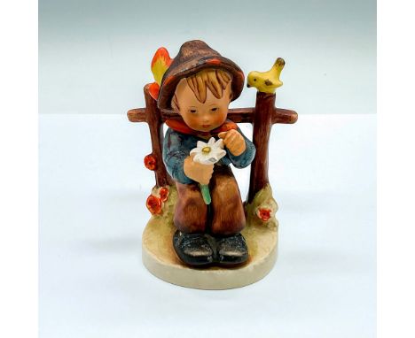 Hand painted figure of a young boy picking flower petals. Goebel Hummel backstamp. HUM 174. Issued: c. 1950-1959Dimensions: 3