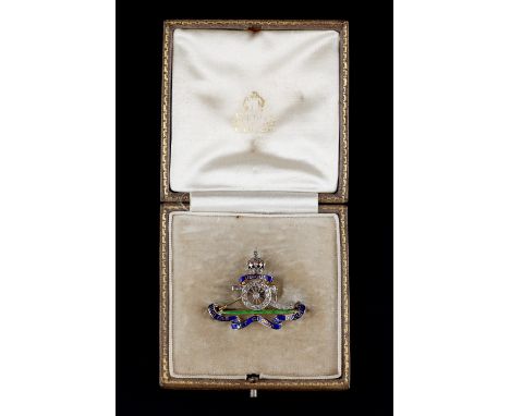 AN ENAMEL AND DIAMOND SET REGIMENTAL BROOCH FOR THE ROYAL ARTILLERY, designed as a muzzle-loading gun surmounted by a crown, 