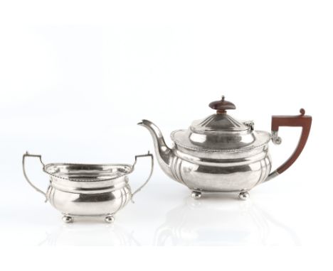 A SILVER TEAPOT and twin handled sucrier, with gadrooned borders, the teapot with composition handle and knop by Harrods Ltd 