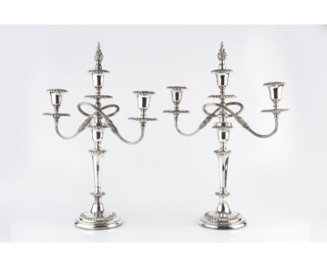 A PAIR OF SILVER PLATED TWIN BRANCH THREE LIGHT CANDELABRA, with gadrooned borders, and reeded detachable branches, 48.5cm hi