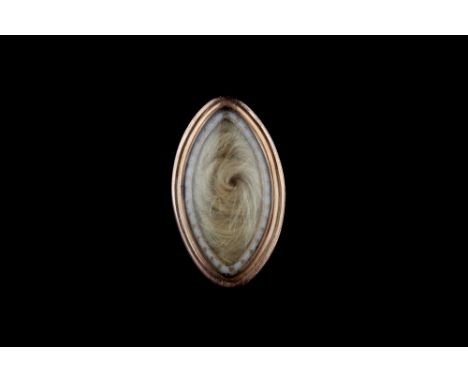 A GEORGE III MEMORIAL RING, the glazed navette-shaped panel enclosing hairwork, within a white enamel beaded border, (later s