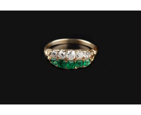 AN ANTIQUE EMERALD AND DIAMOND HALF HOOP RING, of double row design, the scroll decorated hoop with five graduated old-cut di