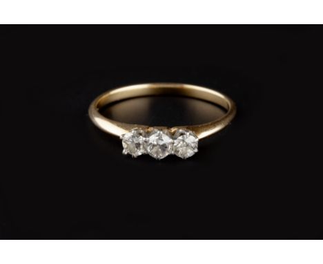 A DIAMOND THREE STONE RING, the round brilliant-cut diamonds in claw setting, two colour precious metal mounted, initialled t