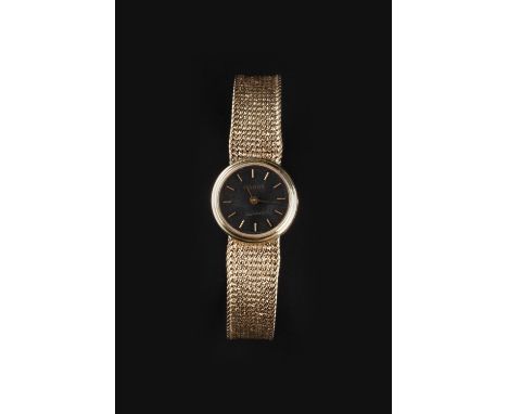 A LADY'S 9CT GOLD BRACELET WATCH BY TISSOT, the circular signed black dial with baton markers, to a quartz movement and taper