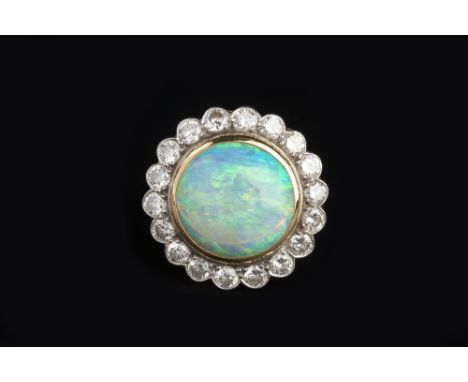 AN OPAL AND DIAMOND CLUSTER RING, the circular cabochon opal collet set within a border of round brilliant-cut diamonds, abov