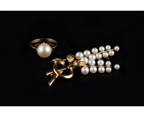 A CULTURED PEARL SPRAY BROOCH BY MIKIMOTO , designed as a tied foliate spray of graduated cultured pearls, yellow precious me