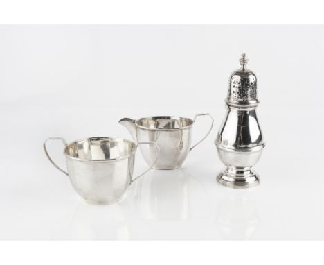 A SILVER SUGAR CASTOR of girdled baluster form, by Garrard & Co, London 1973, 17.5cm high, 7.5 oz; together with a faceted si