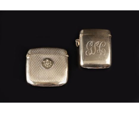 A 9CT GOLD VESTA CASE, with engine turned decoration, monogrammed, 4.5cm high, and another similar, 46.5 gms overall (2)