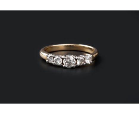 A DIAMOND FIVE STONE RING, the principal round brilliant-cut diamond claw set between pairs of smaller similarly-cut diamonds