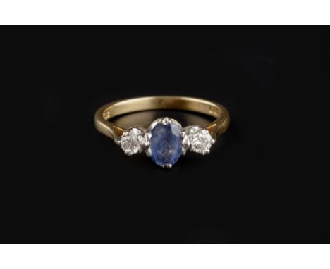 A SAPPHIRE AND DIAMOND THREE STONE RING, the oval mixed-cut sapphire claw set between two round brilliant-cut diamonds, 18ct 