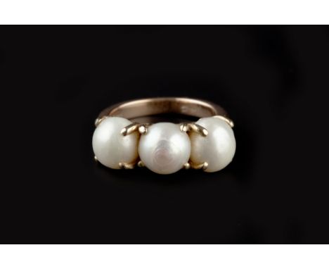 A PEARL THREE STONE RING, the trio of pearls in claw setting, yellow precious metal mounted, stamped '14c', (pearls untested 