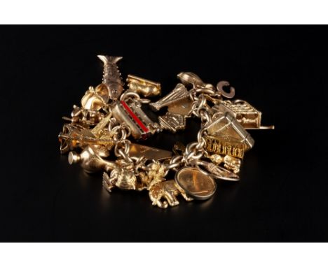 A CHARM BRACELET, the 9ct gold belcher-link bracelet suspending a collection of gold, yellow metal and gilt metal charms, to 