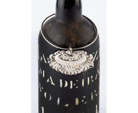 A 19TH CENTURY SCOTTISH PROVINCIAL SILVER DECANTER LABEL FOR MADEIRA, repoussé decorated with fruiting vine and scallop, on w
