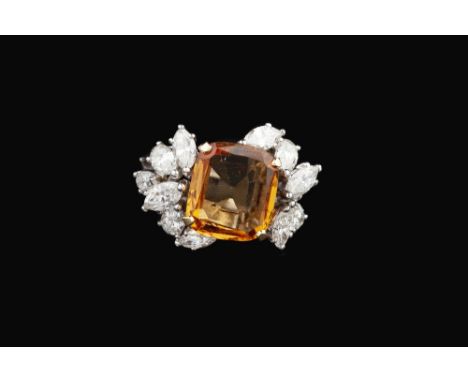 A TOPAZ AND DIAMOND DRESS RING BY COLLINGWOOD, the cushion-shaped mixed-cut topaz of orange-yellow hue, claw set within a tie