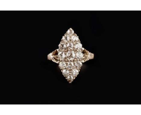 A DIAMOND PANEL RING, the navette-shaped panel of graduated old-cut diamonds between openwork foliate shoulders, yellow preci