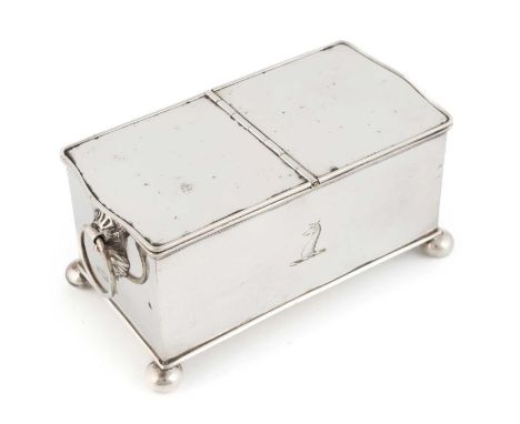 An Edwardian silver inkstand,by Daniel &amp; John Wellby, London 1908rectangular form with mask ring handles, engraved crest,