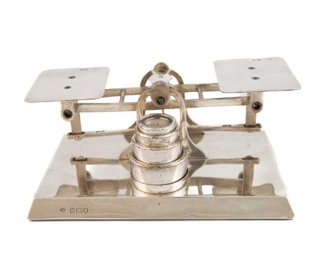 A set of silver letter scales,by George Betjemann &amp; Sons, London 1912,on a raised rectangular base, square-shaped platfor