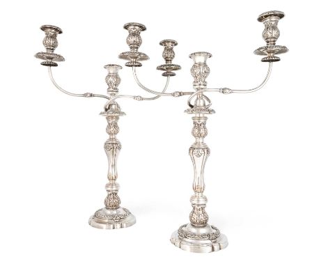 A pair of 19th century old Sheffield plated candelabras,unmarked, circa 1820,knopped baluster form with acanthus leaf decorat