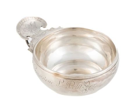 A Louis XV French provincial silver wine taster,probably by Antoine Lagenet, Rouen 1744-50,circular form, the shaped scroll t