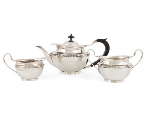A silver three-piece tea set,by Norton &amp; White, Birmingham 1910,tapering circular form with a moulded border, length hand