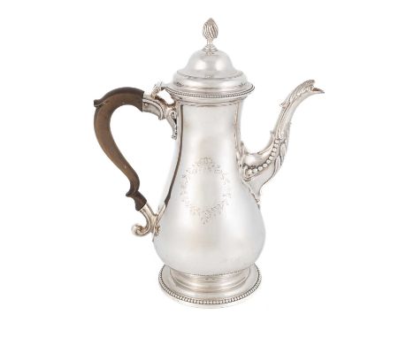 A George III silver coffee pot,by William Grundy, London 1774,baluster form, scroll handle, engraved foliate cartouches, heig