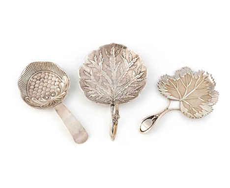A collection of three antique silver caddy spoons, comprising: a George III one by Wardell & Kempson, Birmingham 1813, the sh