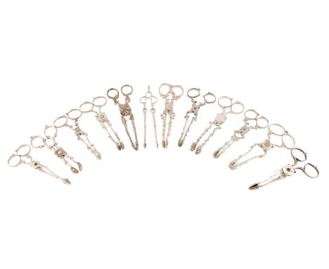A mixed lot of antique silver sugar nips and tongs,comprising: a Dutch pair of andiron tongs, nine pairs of nips with scroll 