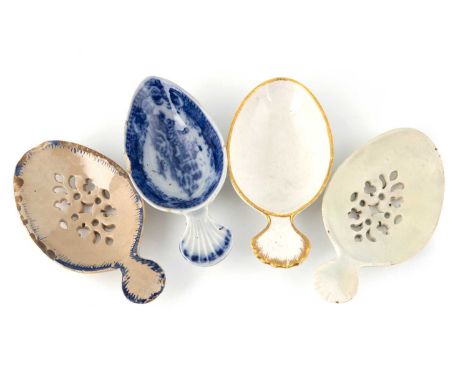 Four ceramic egg separating/caddy spoons, including two with pierced bowls, one with a gilt border and one with a blue orient