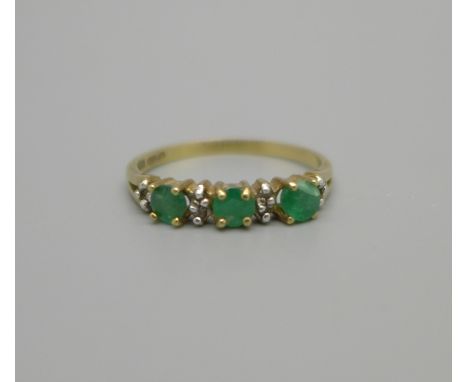 A 9ct gold ring set with emeralds and white stones, one emerald a/f, 1.6g, O 