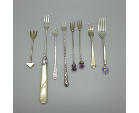 Seven silver olive forks and one other silver commemorative fork, total weight 86g 