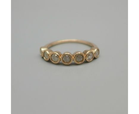 A 9ct gold, seven stone diamond ring, 1.8g, L 