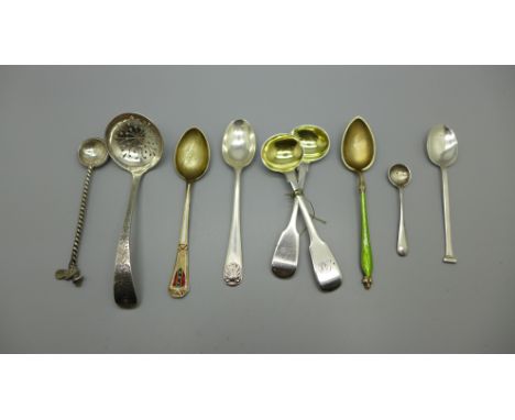 A pair of Victorian silver mustard spoons, Newcastle 1855, Gowland Brothers, a silver sifter spoon, a silver and green enamel