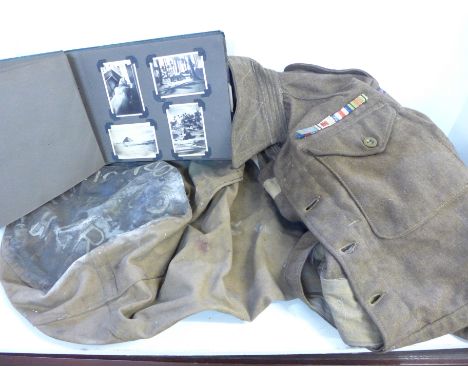 An Army uniform and kit bag and an album of phographs taken whilst on active service in North Africa 