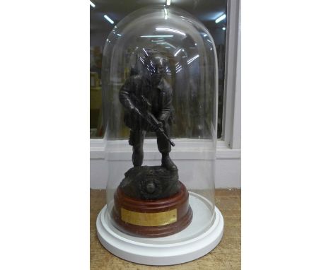 A resin model of a Royal Marine on a wooden plinth with plaque under a glass dome, dome 36cm 