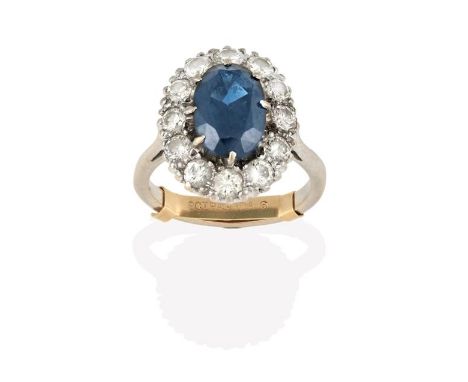 A Sapphire and Diamond Cluster Ring, the oval cut sapphire within a border of round brilliant cut diamonds, in white claw set