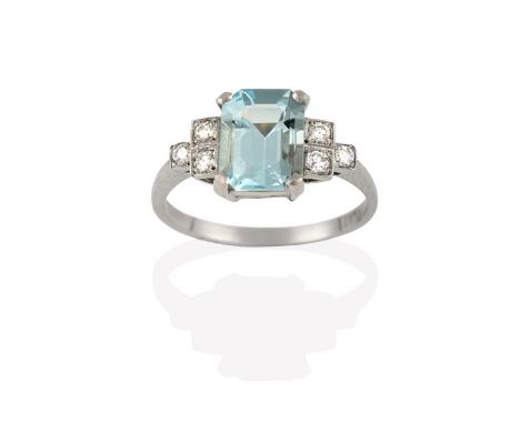 An Art Deco Style Aquamarine and Diamond Ring, the emerald-cut aquamarine in a white claw setting, to round brilliant cut dia