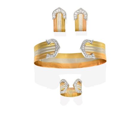 An 18 Carat Tri-Coloured Gold Diamond Bangle, Ring and Earring Suite, of broad ridged cuff design, with eight-cut diamond set