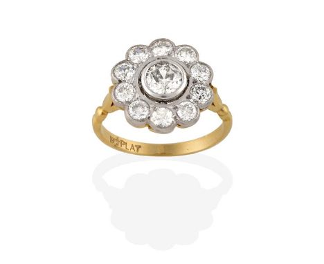 A Diamond Cluster Ring, an old cut diamond within a spaced border of smaller old cut diamonds, in white rubbed over and mille