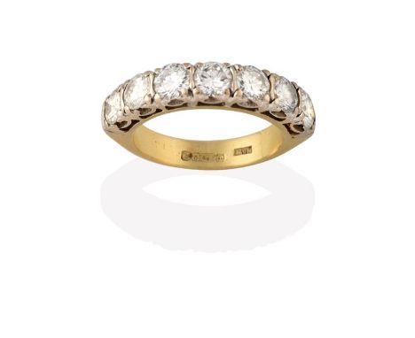 An 18 Carat Gold Diamond Seven Stone Ring, the round brilliant cut diamonds in white claw settings, to a yellow plain polishe