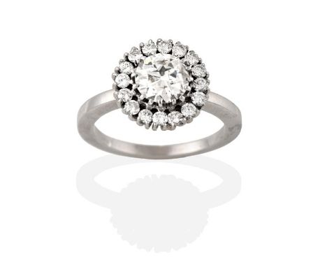 A Diamond Cluster Ring, the round brilliant cut diamond within a border of smaller round brilliant cut diamonds, in white cla