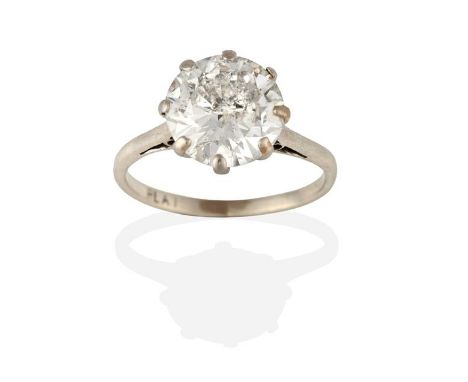 A Diamond Solitaire Ring, the round brilliant cut diamond in a white claw setting, to a tapered shoulder plain polished shank