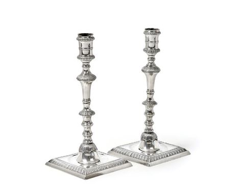 A Pair of George III Silver Candlesticks, Maker's Mark WT, London, 1774, each on stepped square gadrooned base, with baluster