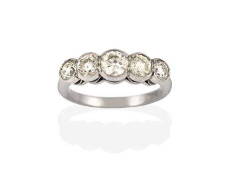 A Diamond Five Stone Ring, the graduated round brilliant cut diamonds in white rubbed over settings, to a tapered shoulder pl