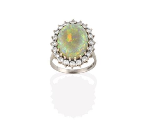 An 18 Carat White Gold Opal and Diamond Cluster Ring, the oval cabochon opal within a border of round brilliant cut diamonds,