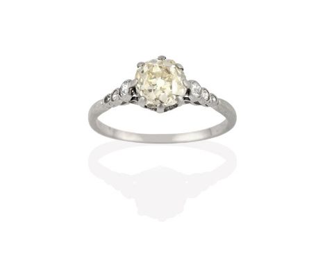 A Diamond Solitaire Ring, the old cut diamond in a white claw setting, to graduated old cut diamond set shoulders on a plain 