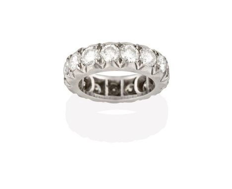 A Diamond Eternity Ring, fifteen round brilliant cut diamonds in white claw settings, total estimated diamond weight 4.20 car